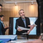 group of businesspeople sitting together in a meeting for best ideas, international executive team