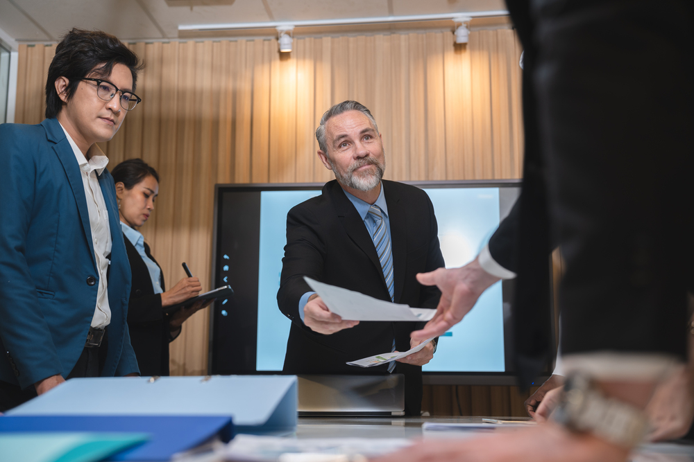 group of businesspeople sitting together in a meeting for best ideas, international executive team